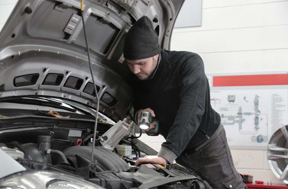 A title loan inspector checking the value of a vehicle.